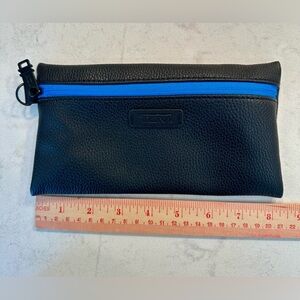 TUMI Black Travel Bag with Vibrant Blue Zipper